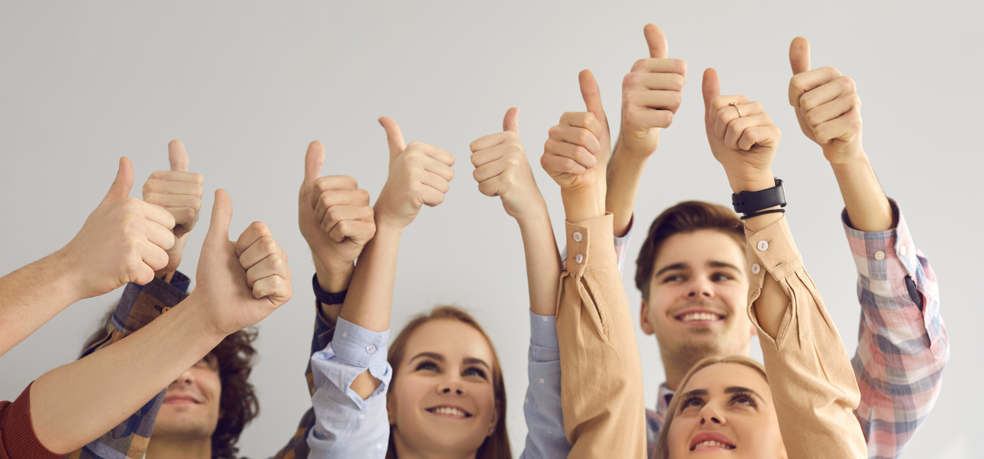 Group of People Giving Thumbs-up Showing Their Satisfaction and Positive Attitude